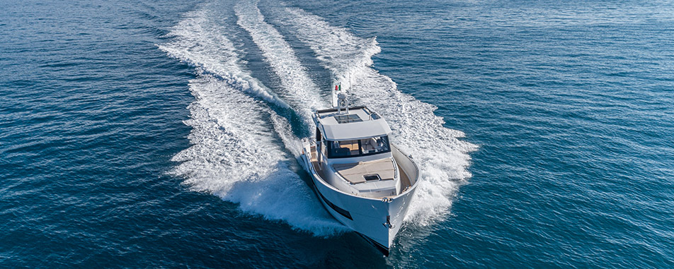 White motor yacht cruising on calm blue ocean water - www.vanpeltinsurance.com